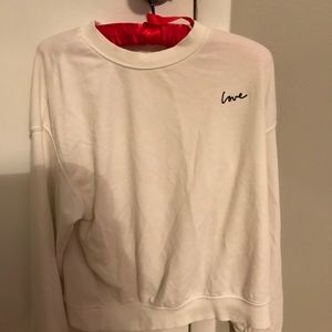 white sweatshirt with the word love on it